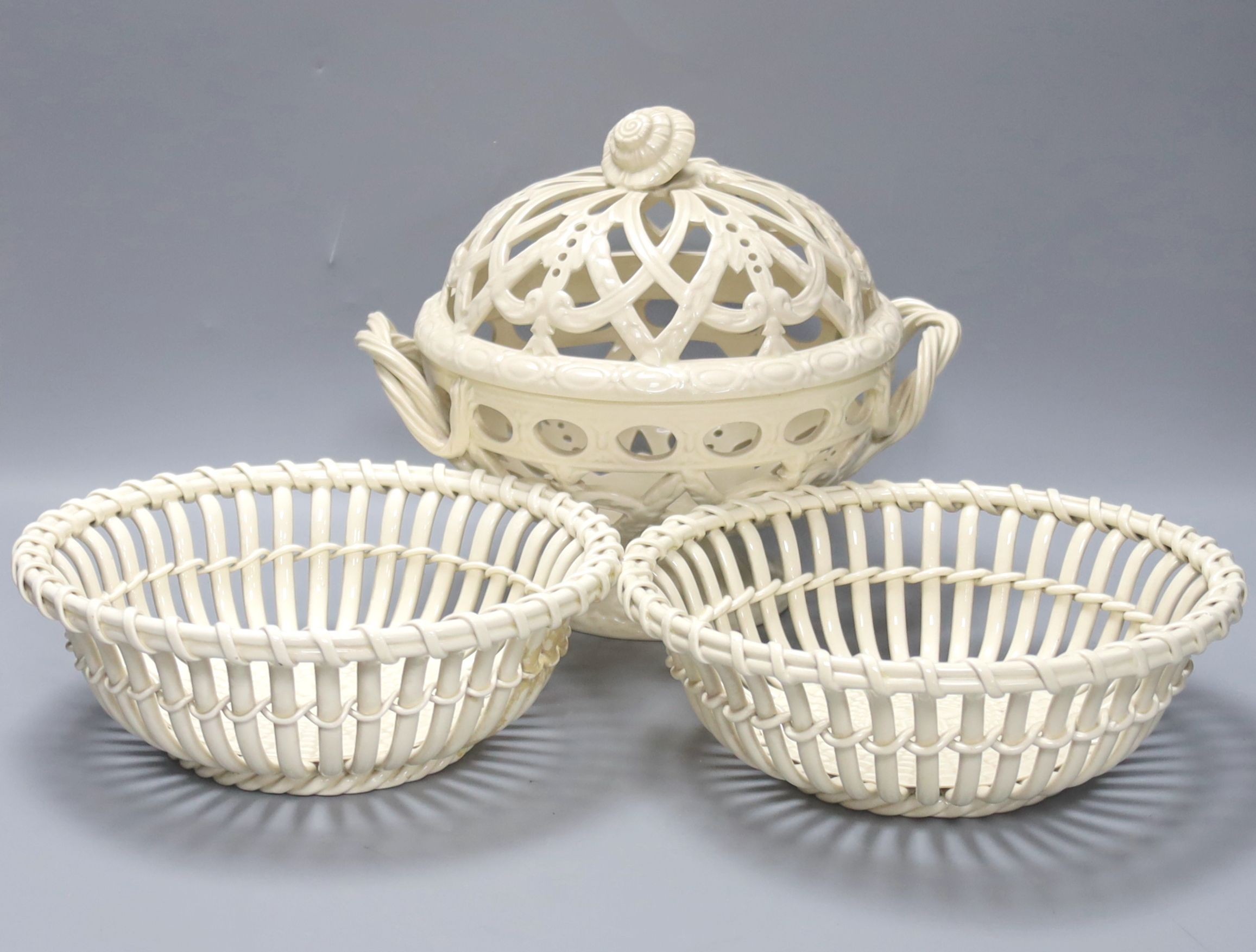 A Victorian Wedgwood creamware covered basket and two Continental creamware baskets, 22cm
